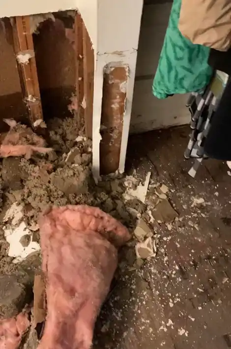 Wall cut open with the insulation pulled out