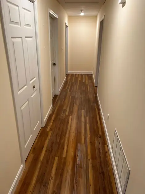 Hallway with finished plank flooring