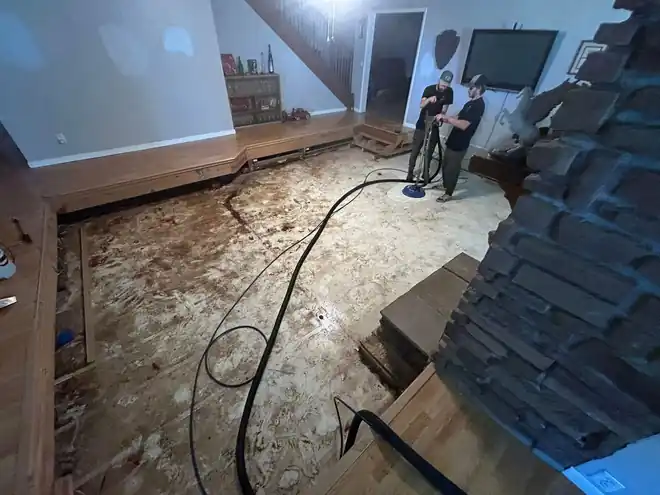 Floor cavity being cleaned out with an extraction wand