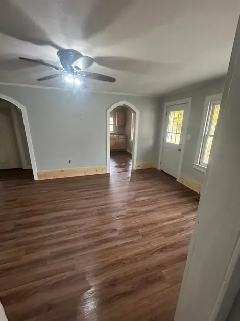 Finished dining room with a plank floor and ceiling fan